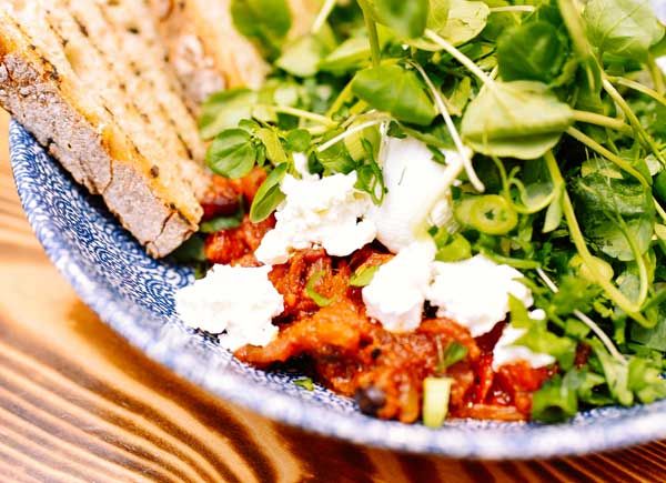 Greens, goats cheese on toast from the Social Fabric Cafe's breakfast menu